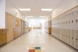 View of an empty school hallway, lined with lockers