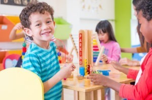 New technologies: Kindergarten students smile when playing toy in class